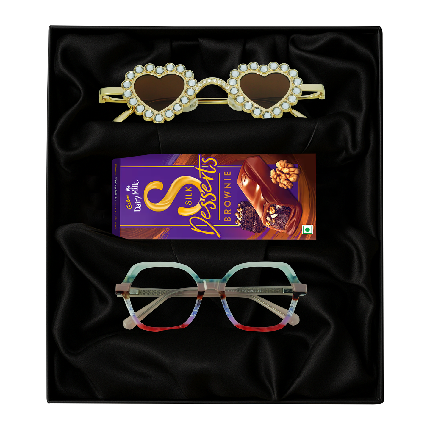 Cadbury Dairy Milk Sweets, and a pair of eyeglasses on a black gift box